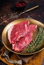 Freah Raw cap rump beef meat steak in a plate with thyme, top sirloin steak. Dark background. Top view Royalty Free Stock Photo