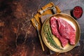 Freah Raw cap rump beef meat steak in a plate with thyme, top sirloin steak. Dark background. Top view. Copy space Royalty Free Stock Photo