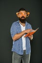 Freak and geek. Bearded man in party glasses reading book. Study nerd holding lesson book. University male student with