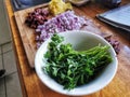Freash parsley, chopped onions and olives on a wooden kitchen bench