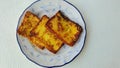 Frech toasts in a blue leave patterned plate with blue outline.