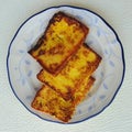 Frech toasts in a blue leave patterned plate with blue outline.