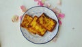 Frech toasts in a blue leave patterned plate with blue outline.