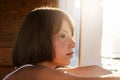 Freckled child with bobbed hairdo, looking into distanse, admiring beautiful sea landscapes, dreaming about something. Little girl Royalty Free Stock Photo