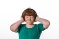 Freckled red-hair boy listening music. Royalty Free Stock Photo