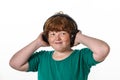 Freckled red-hair boy listening music. Royalty Free Stock Photo