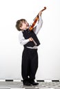 Freckled red-hair boy playing violin. Royalty Free Stock Photo