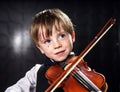 Freckled red-hair boy playing violin. Royalty Free Stock Photo