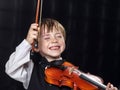 Freckled red-hair boy playing violin. Royalty Free Stock Photo