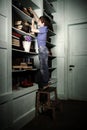 Freckled red-haired little boy searching book on bookcase Royalty Free Stock Photo