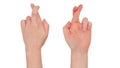 Freckled white hands. Isolated woman`s hand in a fingers crossed gesture, little and ring fingers tucked in