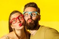 Freckled woman, and bearded man send air kissing at camera