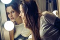Freckles woman looking at mirror. Beautiful brunette stands Royalty Free Stock Photo