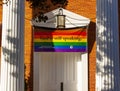 Close up image of the front door of the Evangelical Reformed United Church of Christ with a large LGBT flag Royalty Free Stock Photo