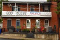 A run down house with a God Bless America banner