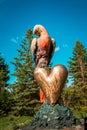 Frederik Meijer Gardens - Grand Rapids, MI /USA - September 4th 2016: Statue of a parrot perched on a hear in the Frederik Meijer