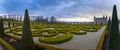 Frederiksborg castle , with ornamental landscape gardened shrubs in the foreground