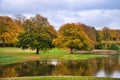 Frederiksborg Castle Park with mighty deciduous trees, reflected in the created lake Royalty Free Stock Photo