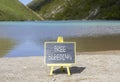 Free bleeding symbol. Concept words Free bleeding on beautiful black chalk blackboard. Beautiful mountain lake background. Gen Z,