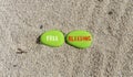Free bleeding symbol. Concept words Free bleeding on beautiful green stone. Beautiful sea sand beach background. Gen Z,