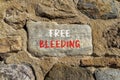 Free bleeding symbol. Concept words Free bleeding on beautiful grey stone. Beautiful brown stone wall background. Gen Z,