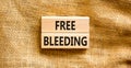 Free bleeding symbol. Concept words Free bleeding on beautiful wooden block. Beautiful canvas table canvas background. Gen Z,