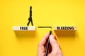 Free bleeding symbol. Concept words Free bleeding on beautiful wooden block. Beautiful yellow table yellow background. Woman icon