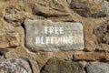 Free bleeding symbol. Concept words Free bleeding on beautiful grey stone. Beautiful brown stone wall background. Gen Z,