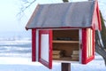 Free book sharing mini house near the river in cold winter morning Royalty Free Stock Photo