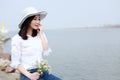 Free careless causual beauty by beach ocean lake river enjoy relax time in summer spring park smile on her face hold a flower Royalty Free Stock Photo