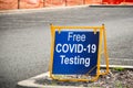 Free COVID-19 testing. Drive through testing clinic sign on a road Royalty Free Stock Photo