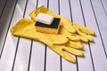 Cleaning set. Sponges, white soap and yellow gloves Royalty Free Stock Photo