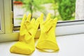 Yellow gloves to protect hands on a dirty windowsill Royalty Free Stock Photo