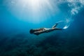 Free diver athlete glides with freediving fins. Freediver girl in sea Royalty Free Stock Photo