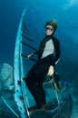 Free diver stands on ship wreck