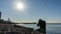 Free diver in wetsuit with flippers ready to dive into the Black sea. Sochi, Russia