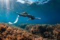 Free diver with white fins posing underwater. Freediving with young girl