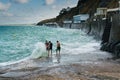 Free divers preparing to jump into stormy ocean waters