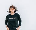 Free feeling happy woman posing in black sweatshirt with positive print Shine On Royalty Free Stock Photo