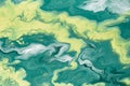 Free flowing yellow and green acrylic paint. Random Waves and Curls. Abstract marble background or texture Royalty Free Stock Photo