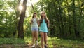 Free girls travelers with backpacks go through the thicket in the forest. children tourists travel in the summer park Royalty Free Stock Photo