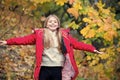 Free and happy cutie. Child blonde long hair walking in warm jacket outdoor. Girl happy in red coat enjoy fall nature Royalty Free Stock Photo