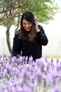 Free, happy, Latin adult woman in harmony and freedom, amid lavender flowers enjoying their beauty and aroma in a moment of relaxa Royalty Free Stock Photo