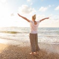 Free Happy Woman Enjoying Sunset on Sandy Beach Royalty Free Stock Photo