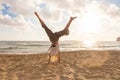 Free Happy Woman Turning Cartwheel Enjoying Sunset on Sandy Beach. Royalty Free Stock Photo