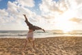 Free Happy Woman Turning Cartwheel Enjoying Sunset on Sandy Beach.