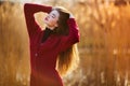 Free happy young woman. Beautiful female with long healthy blowing hair enjoying sun light in park at sunset. Spring Royalty Free Stock Photo