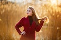 Free happy young woman. Beautiful female with long healthy blowing hair enjoying sun light in park at sunset. Spring Royalty Free Stock Photo