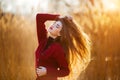 Free happy young woman. Beautiful female with long healthy blowing hair enjoying sun light in park at sunset. Spring Royalty Free Stock Photo