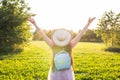 Free happy young woman raising arms watching the sun in the background at sunrise Royalty Free Stock Photo